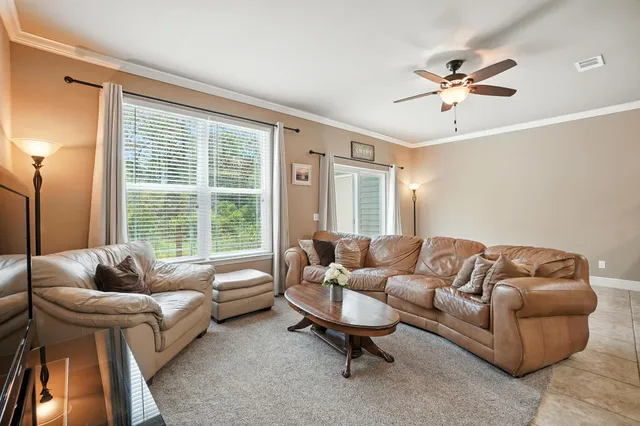 a living room with furniture and a large window