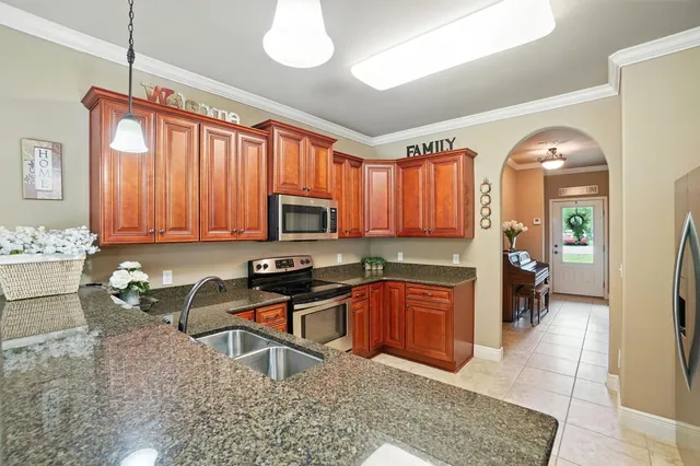 a kitchen that has a lot of cabinets in it and appliances
