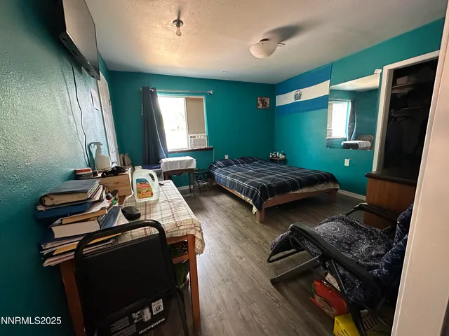 a bedroom with two beds and a window