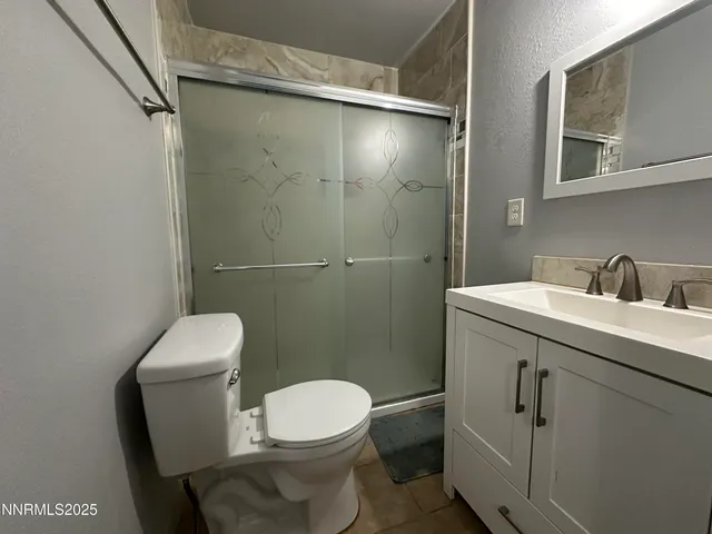 a bathroom with a toilet a sink and shower