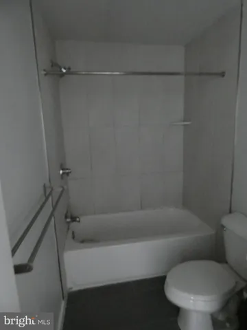 a bathroom with a toilet and a bathtub