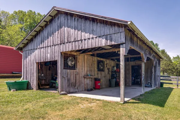 a view of a house with backyard and porch