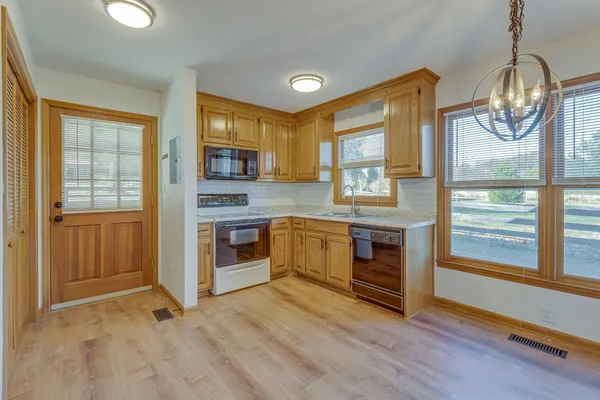 a kitchen with stainless steel appliances granite countertop a stove and a refrigerator