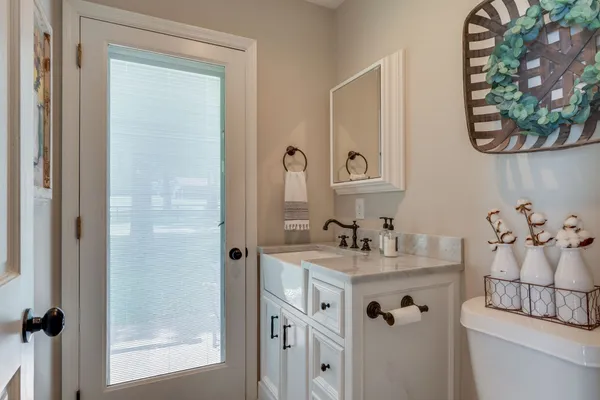 a bathroom with a sink vanity and mirror