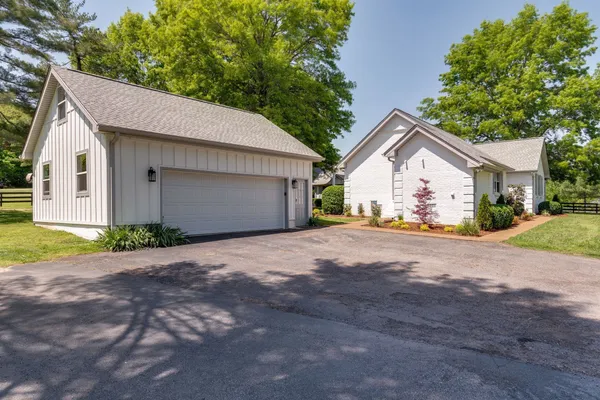 a view of a house with a yard and garage
