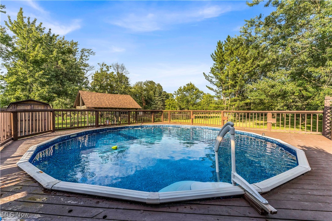 7479 Macedonia Road Bedford, OH 44146 - Photo 10 of 42 View of pool with a wooden deck and a shed