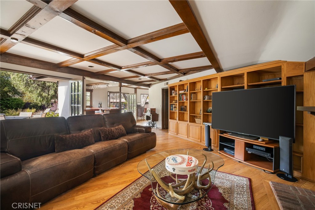 23629 Long Valley Road Hidden Hills, CA 91302 - Photo 11 of 26 a living room with furniture and a flat screen tv