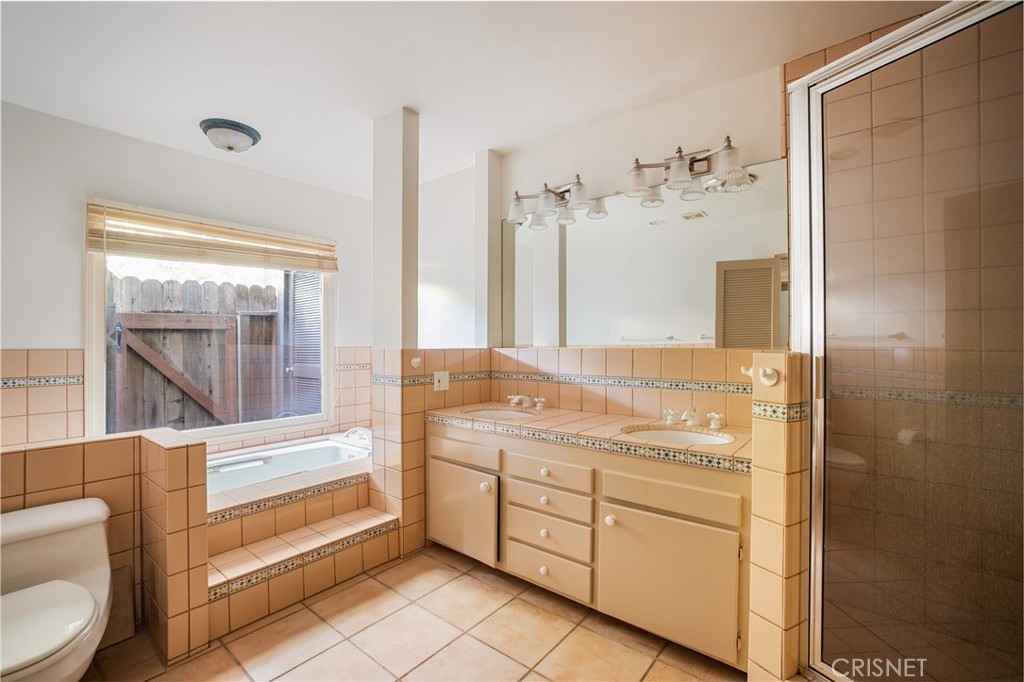 23629 Long Valley Road Hidden Hills, CA 91302 - Photo 14 of 26 a bathroom with a sink a toilet and shower
