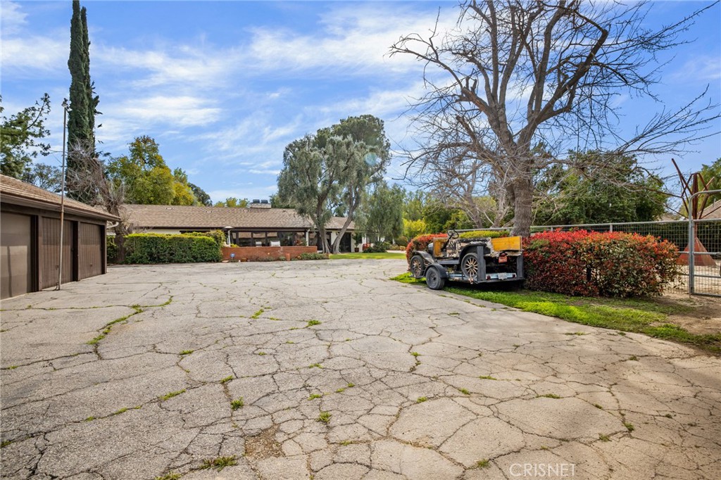 23629 Long Valley Road Hidden Hills, CA 91302 - Photo 19 of 26 a car parked in front of house with a yard
