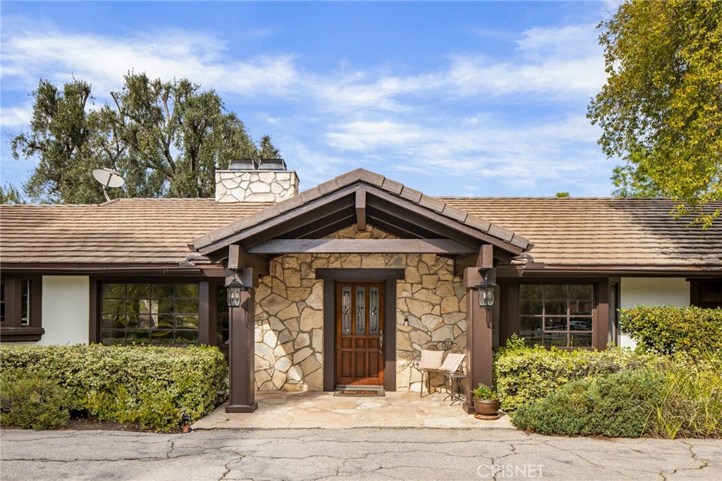 23629 Long Valley Road Hidden Hills, CA 91302 - Photo 2 of 26 front view of a house with a yard