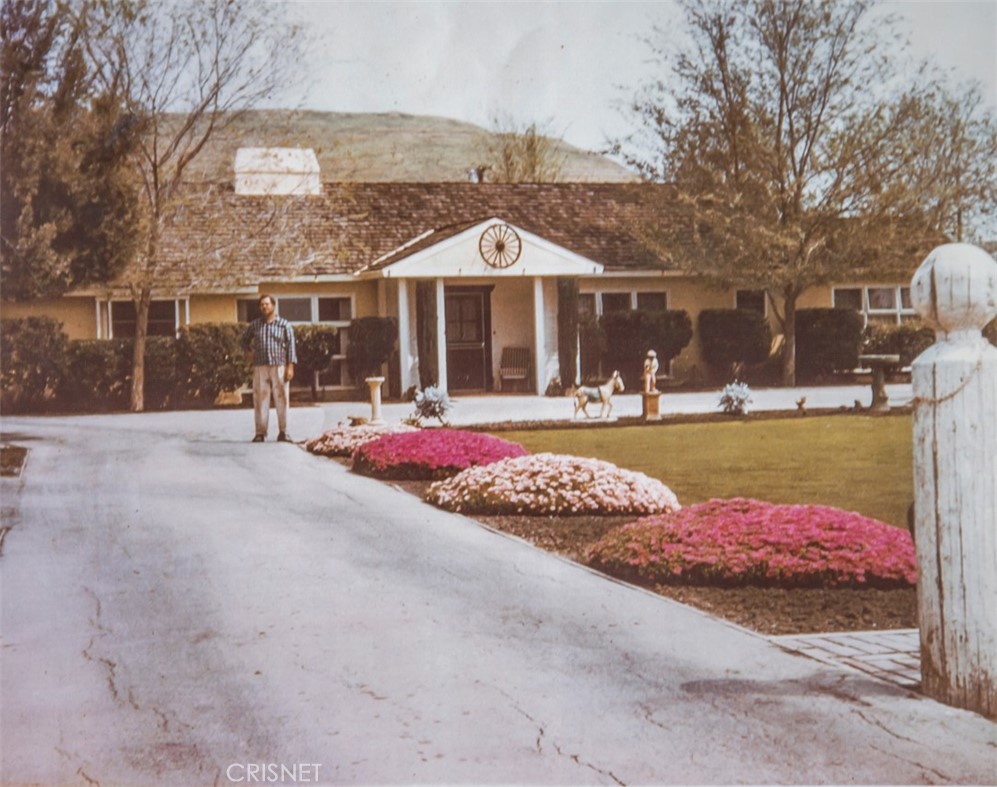 23629 Long Valley Road Hidden Hills, CA 91302 - Photo 26 of 26 a front view of a house with a yard