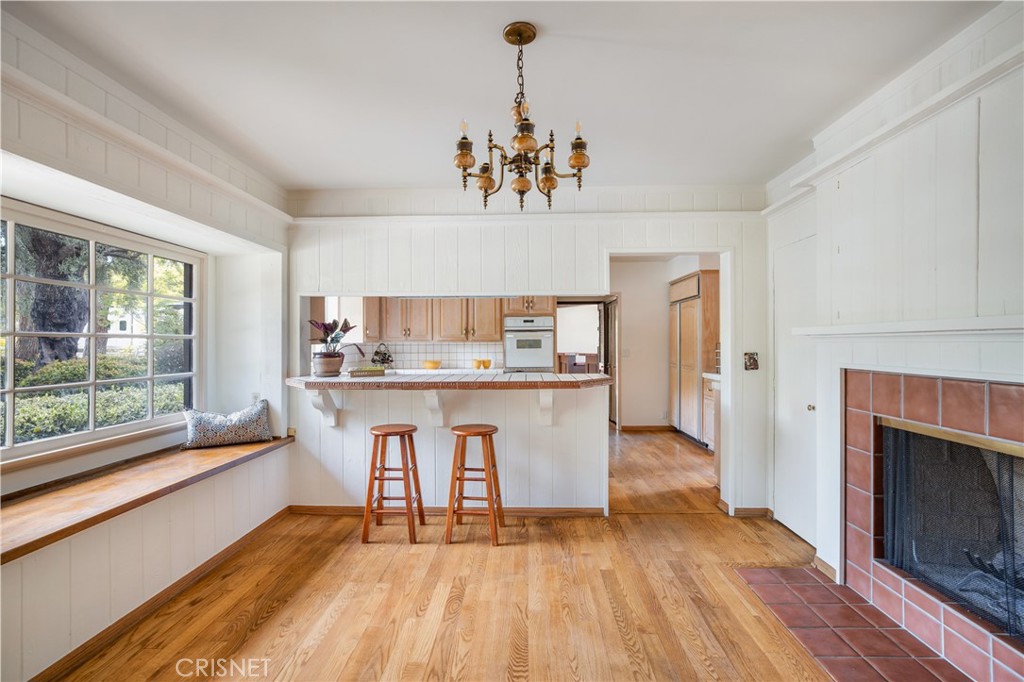 23629 Long Valley Road Hidden Hills, CA 91302 - Photo 7 of 26 a view of open kitchen with granite countertop microwave stove top oven and cabinets