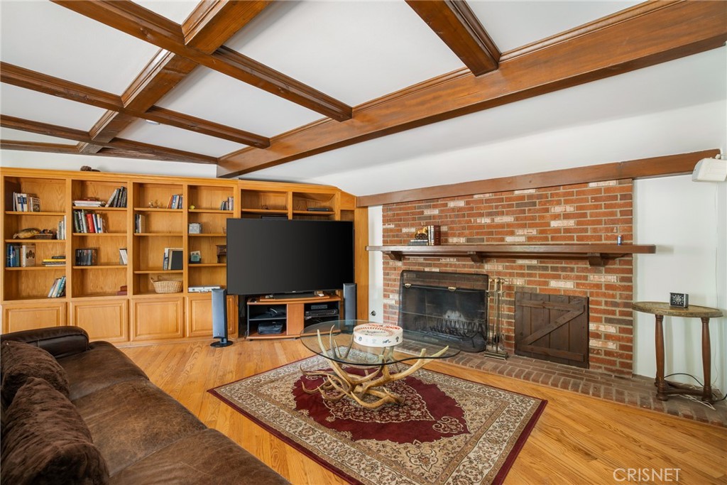 23629 Long Valley Road Hidden Hills, CA 91302 - Photo 10 of 26 a living room with furniture a flat screen tv and a fireplace