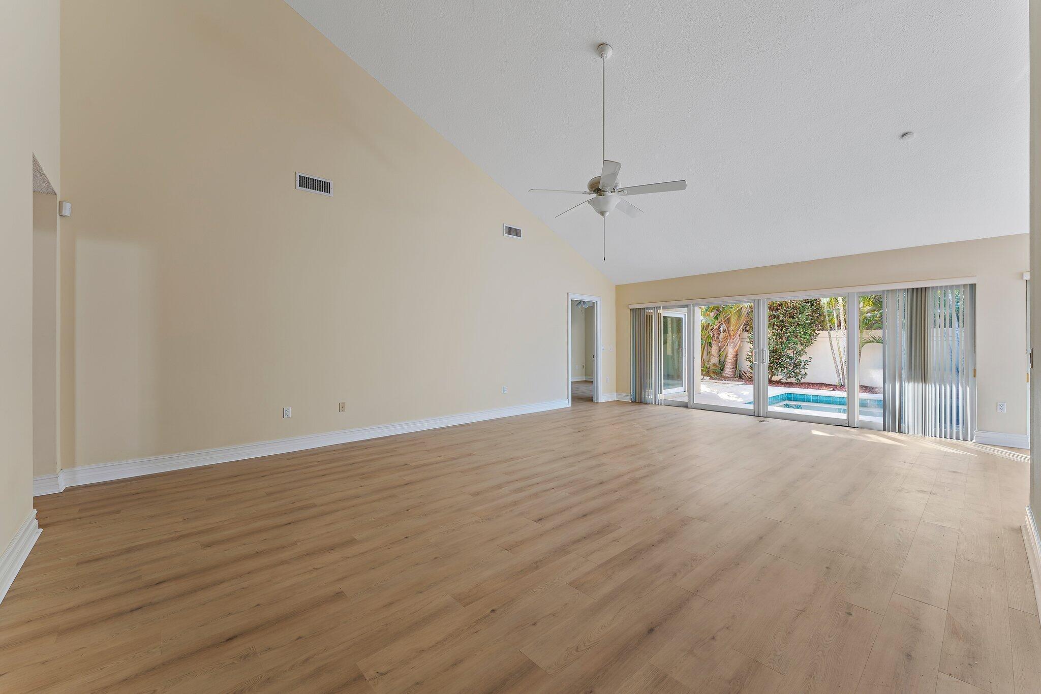 118 Knoll Way Jupiter, FL 33477 - Photo 11 of 40 a view of an empty room with wooden floor and a window