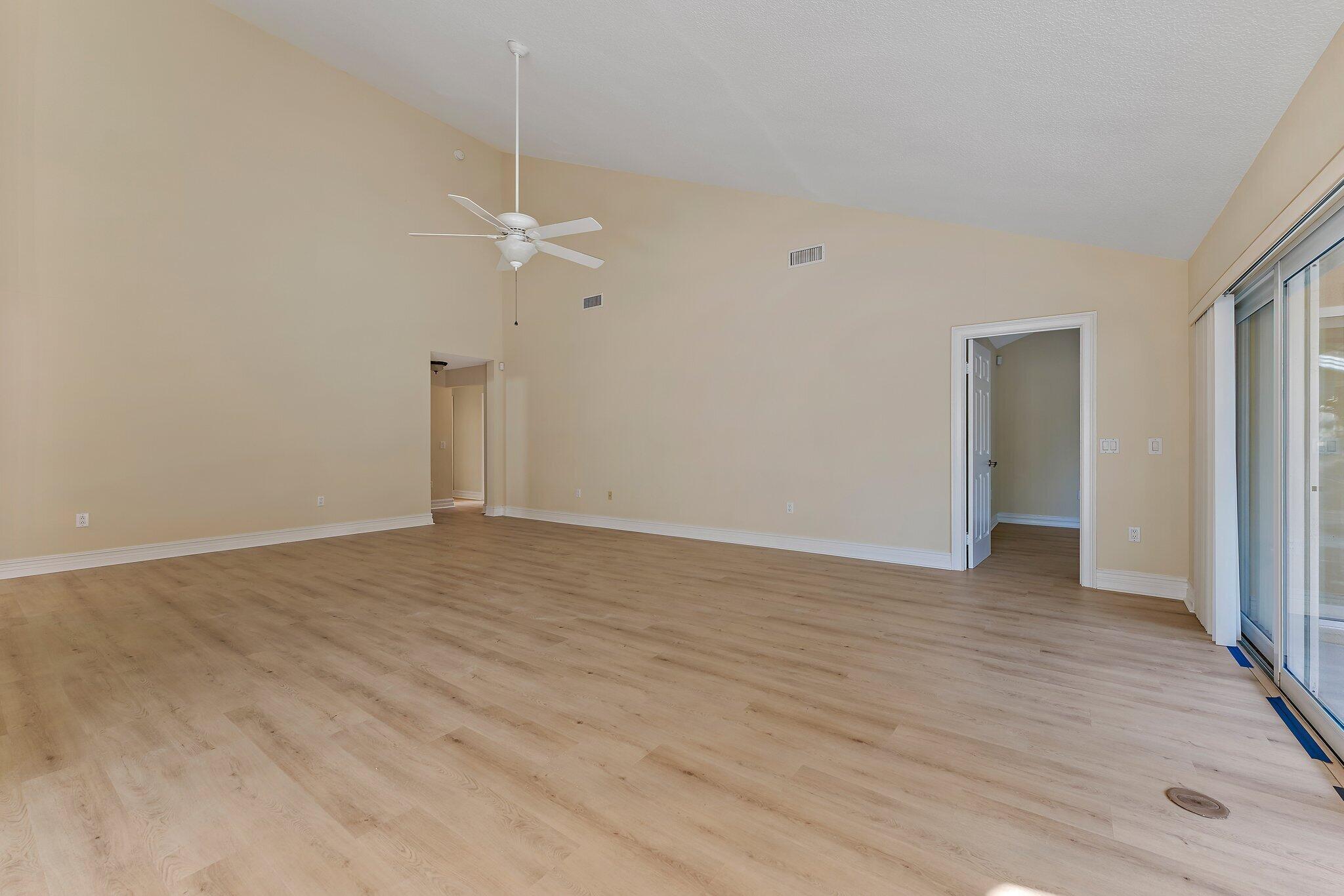 118 Knoll Way Jupiter, FL 33477 - Photo 16 of 40 a view of a room with wooden floor and white walls