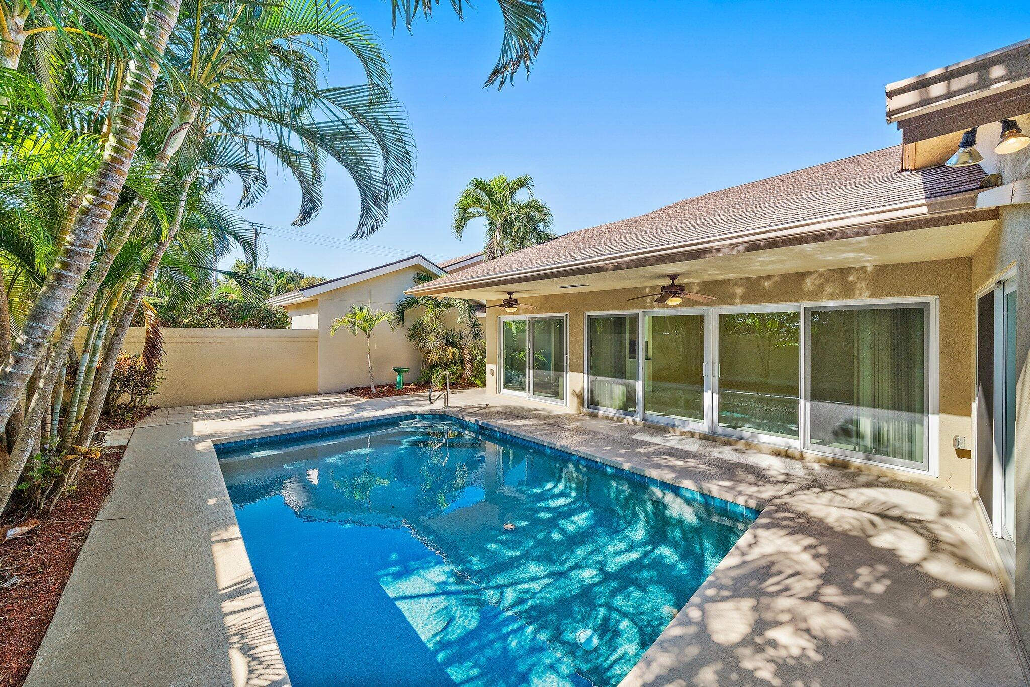 118 Knoll Way Jupiter, FL 33477 - Photo 17 of 40 a view of a house with a swimming pool and sitting area