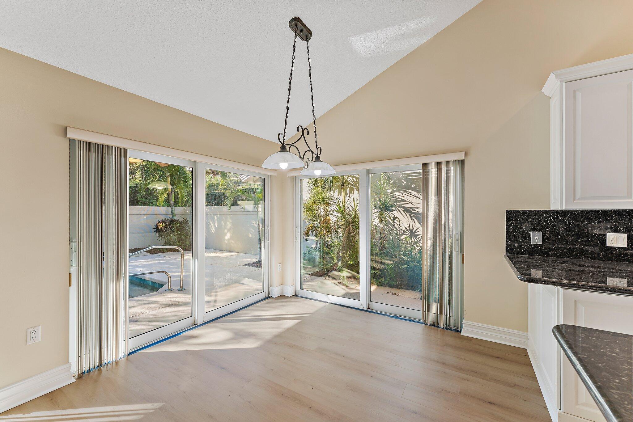 118 Knoll Way Jupiter, FL 33477 - Photo 18 of 40 a view of a room with wooden floor and fireplace
