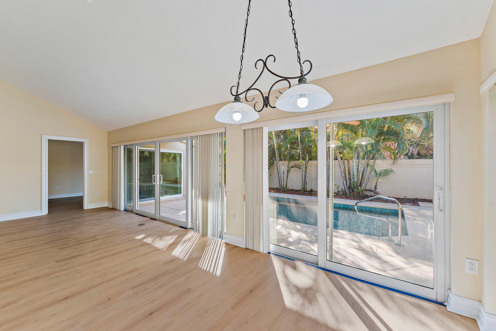 118 Knoll Way Jupiter, FL 33477 - Photo 20 of 40 a view of a room with wooden floor and balcony