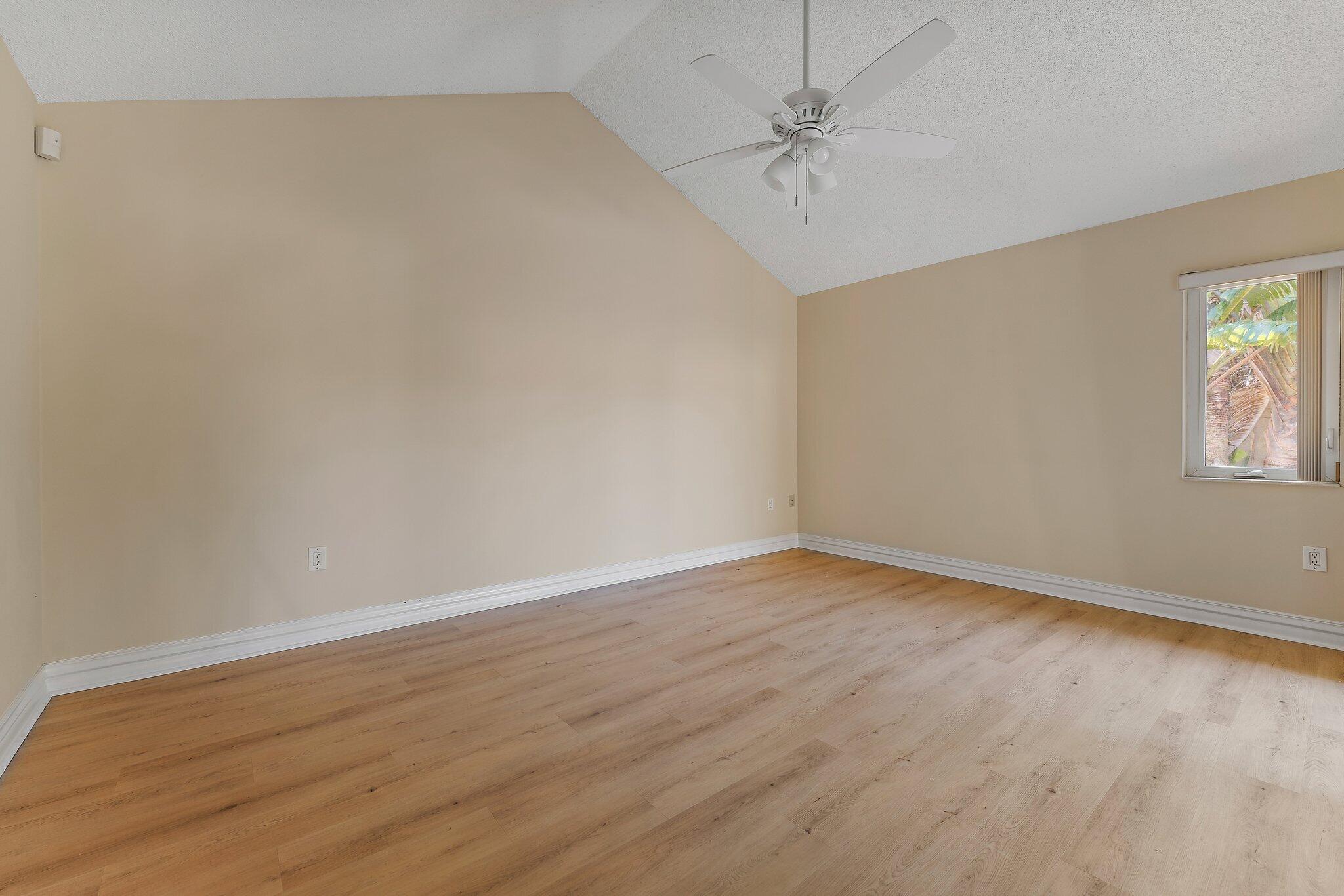 118 Knoll Way Jupiter, FL 33477 - Photo 26 of 40 wooden floor in an empty room with a window