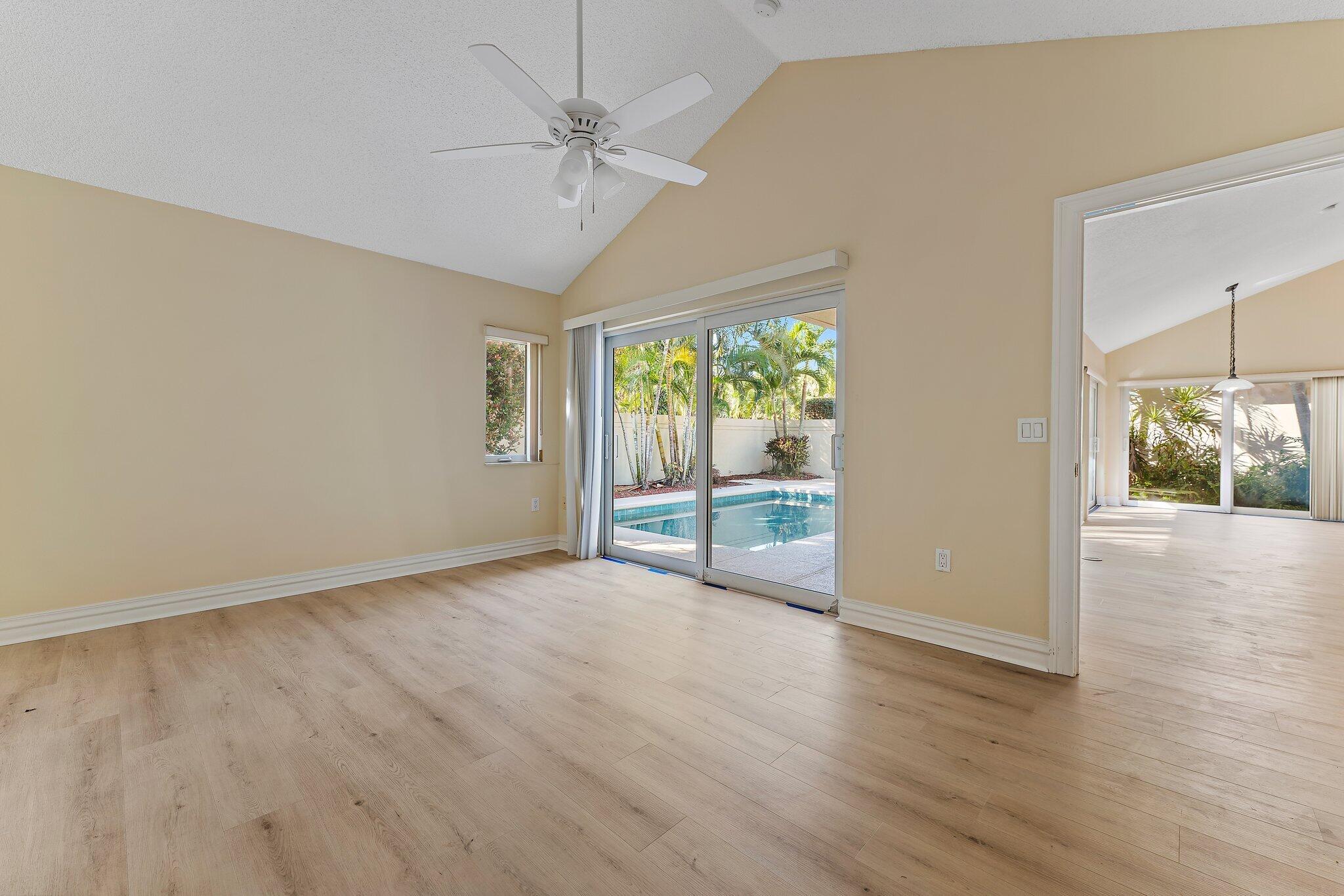 118 Knoll Way Jupiter, FL 33477 - Photo 27 of 40 a view of an empty room with wooden floor and a window