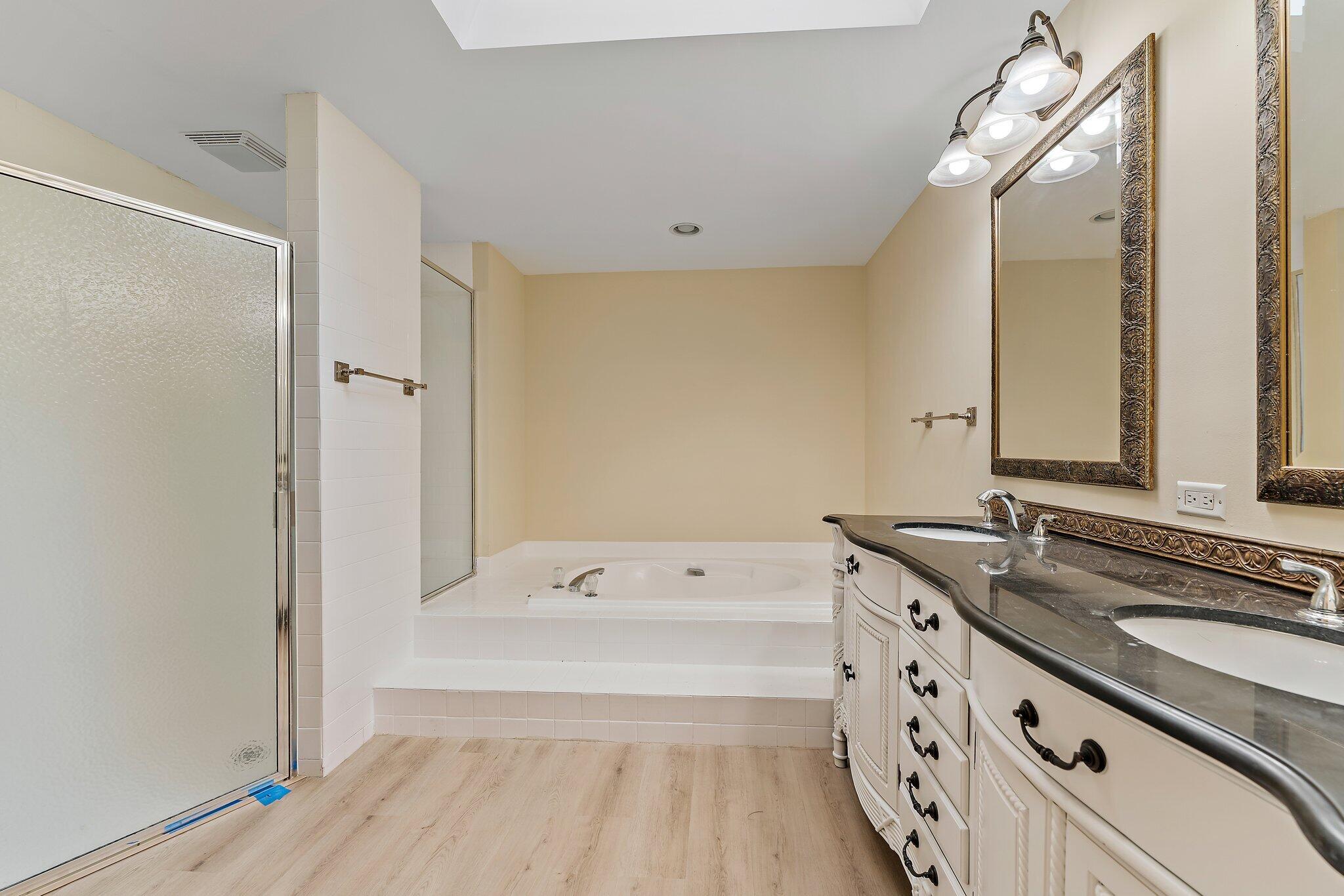 118 Knoll Way Jupiter, FL 33477 - Photo 31 of 40 a spacious bathroom with a tub sink and mirror