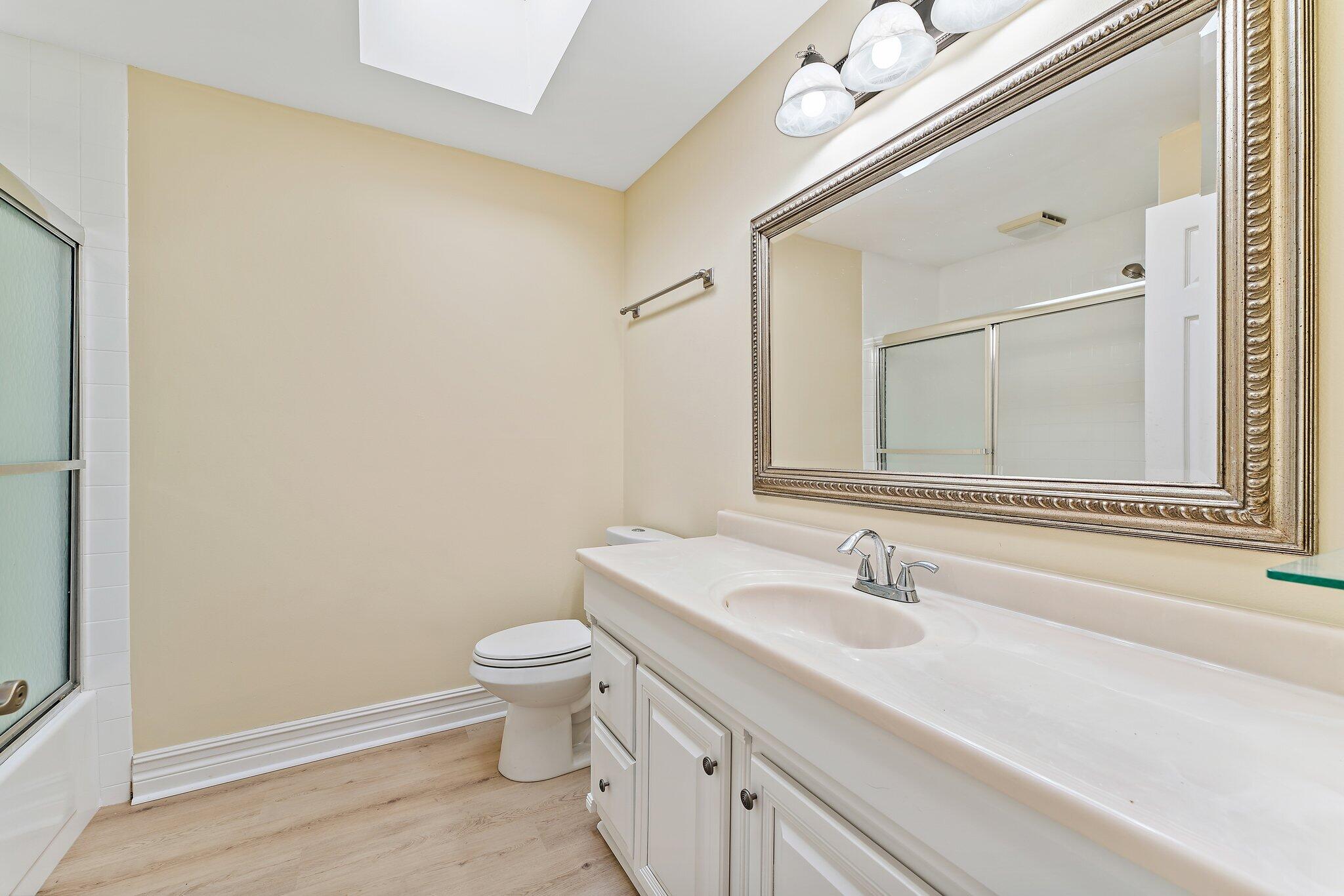 118 Knoll Way Jupiter, FL 33477 - Photo 35 of 40 a bathroom with a sink a toilet and a mirror