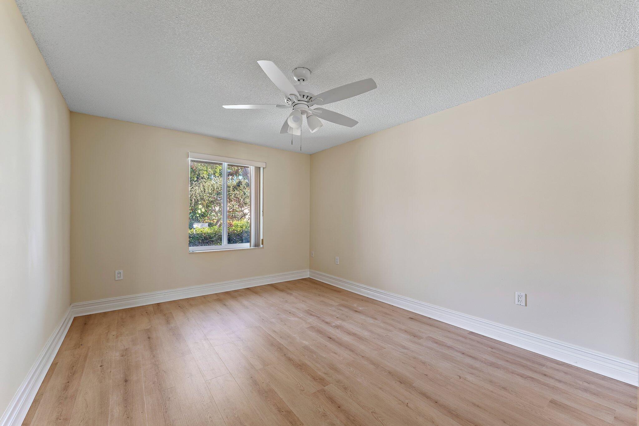 118 Knoll Way Jupiter, FL 33477 - Photo 36 of 40 wooden floor in an empty room with a window