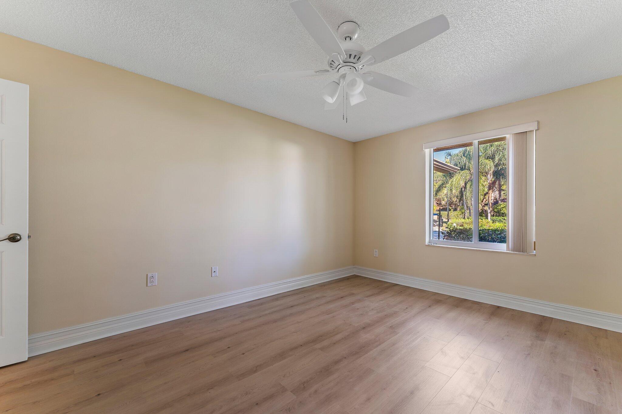 118 Knoll Way Jupiter, FL 33477 - Photo 37 of 40 a view of an empty room with wooden floor and a window