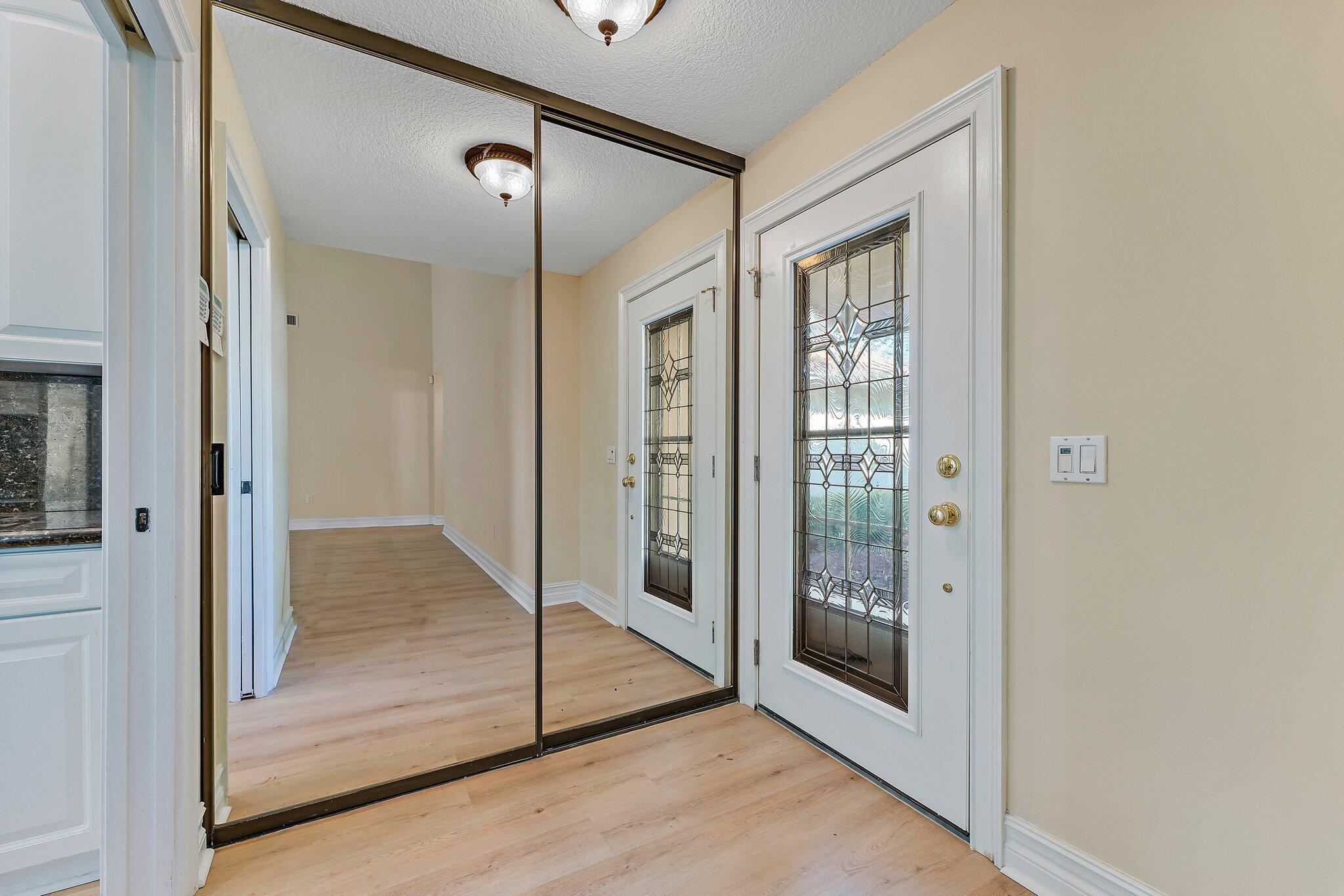 118 Knoll Way Jupiter, FL 33477 - Photo 9 of 40 a view of a bathroom with wooden floor and a glass door