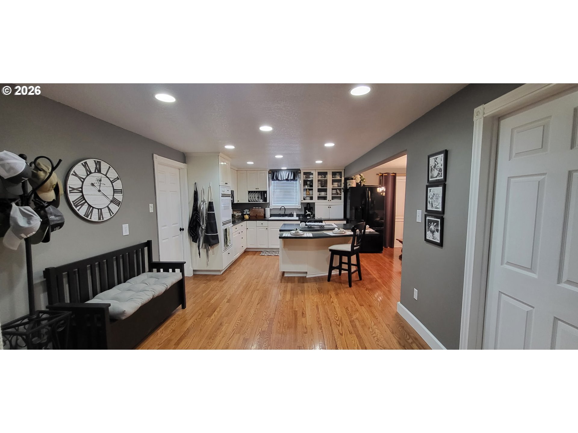 113 Southeast 3rd Avenue Milton Freewater, OR 97862 - Photo 5 of 38 a open kitchen with stainless steel appliances kitchen island granite countertop a refrigerator a stove a oven with white cabinets
