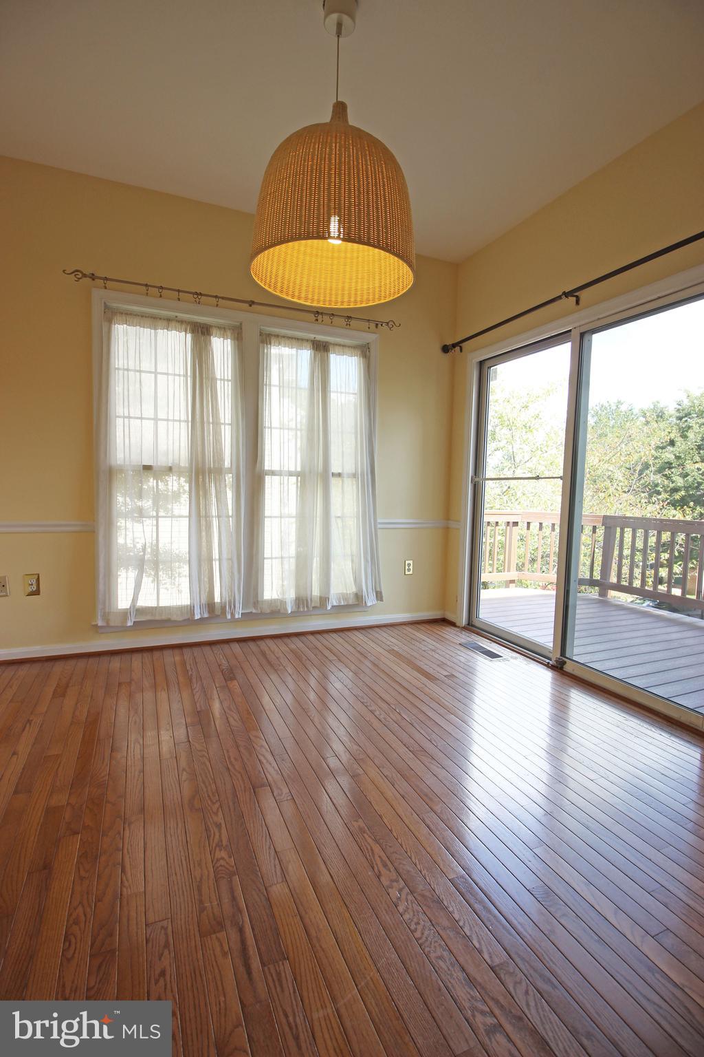 11799 Valley Ridge Circle Fairfax, VA 22033 - Photo 15 of 43 an empty room with wooden floor and windows