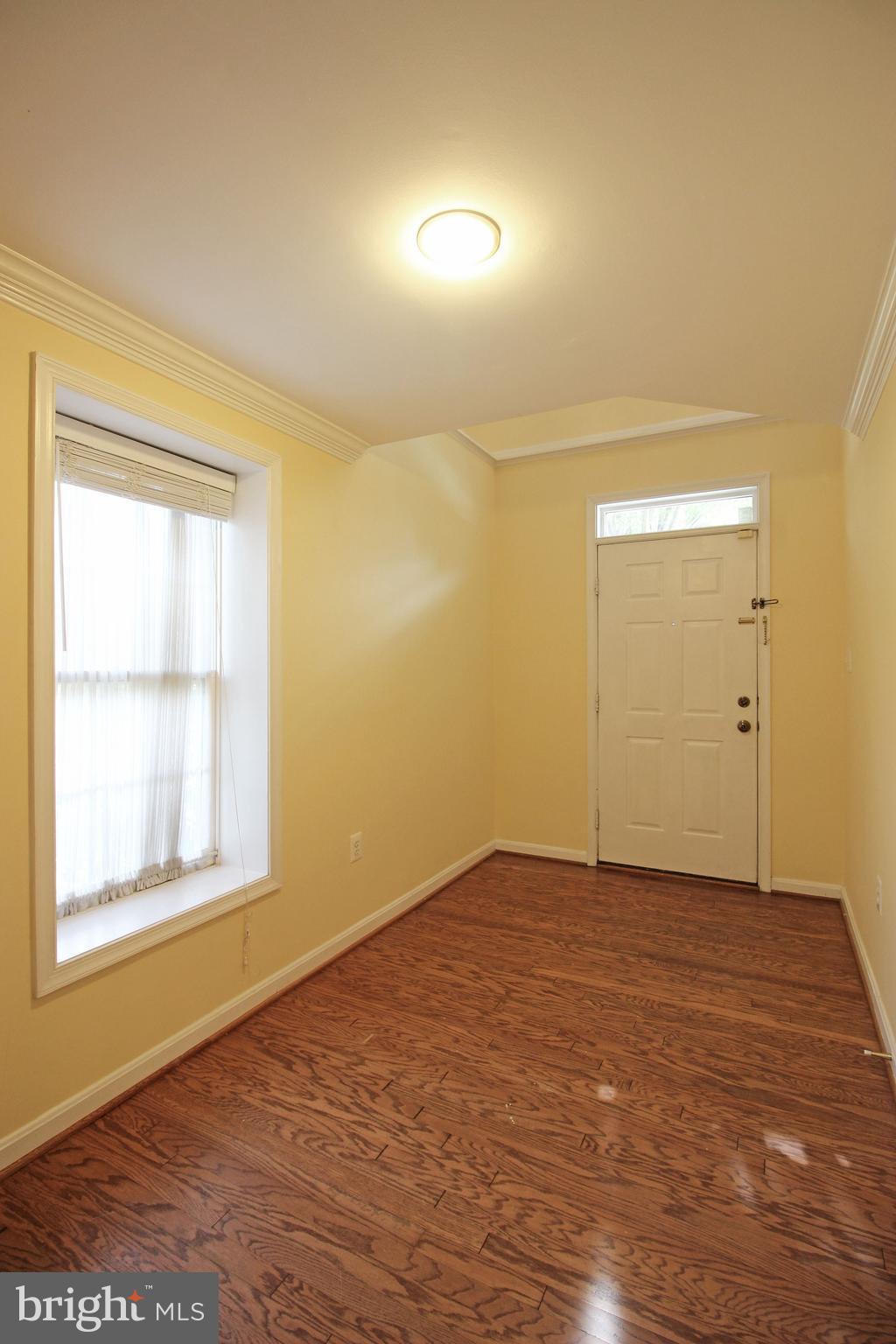 11799 Valley Ridge Circle Fairfax, VA 22033 - Photo 2 of 43 a view of an empty room with wooden floor and a window