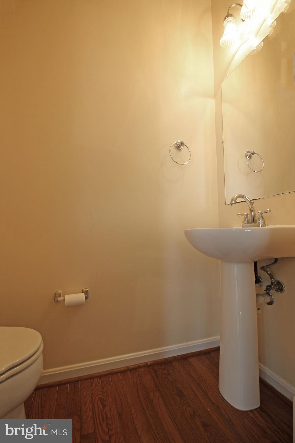 11799 Valley Ridge Circle Fairfax, VA 22033 - Photo 42 of 43 a bathroom with a sink a toilet and a mirror