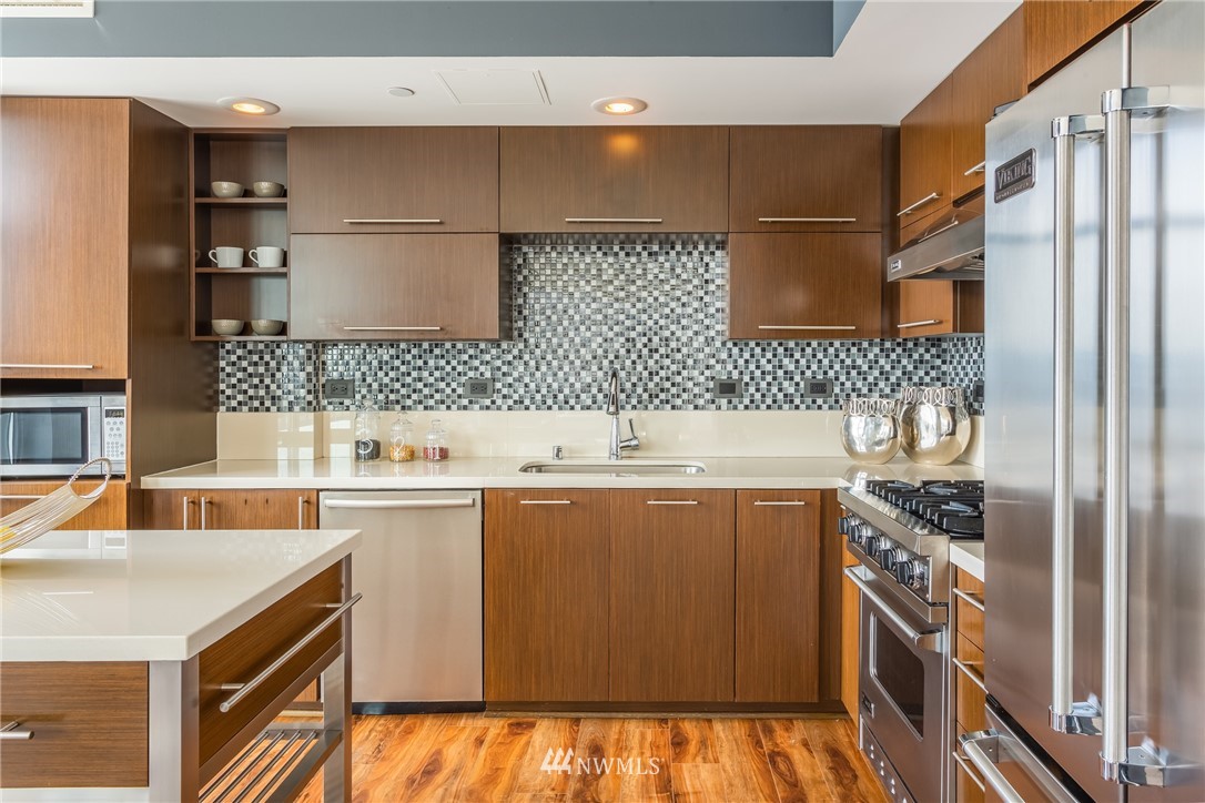 2911 2nd Avenue, Unit 903 Seattle, WA 98121 - Photo 11 of 25 a kitchen with a sink and a stove top oven