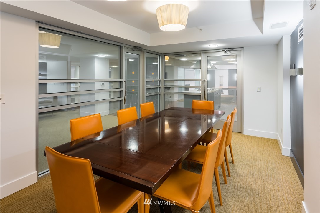 2911 2nd Avenue, Unit 903 Seattle, WA 98121 - Photo 22 of 25 a dining room with furniture and wooden floor