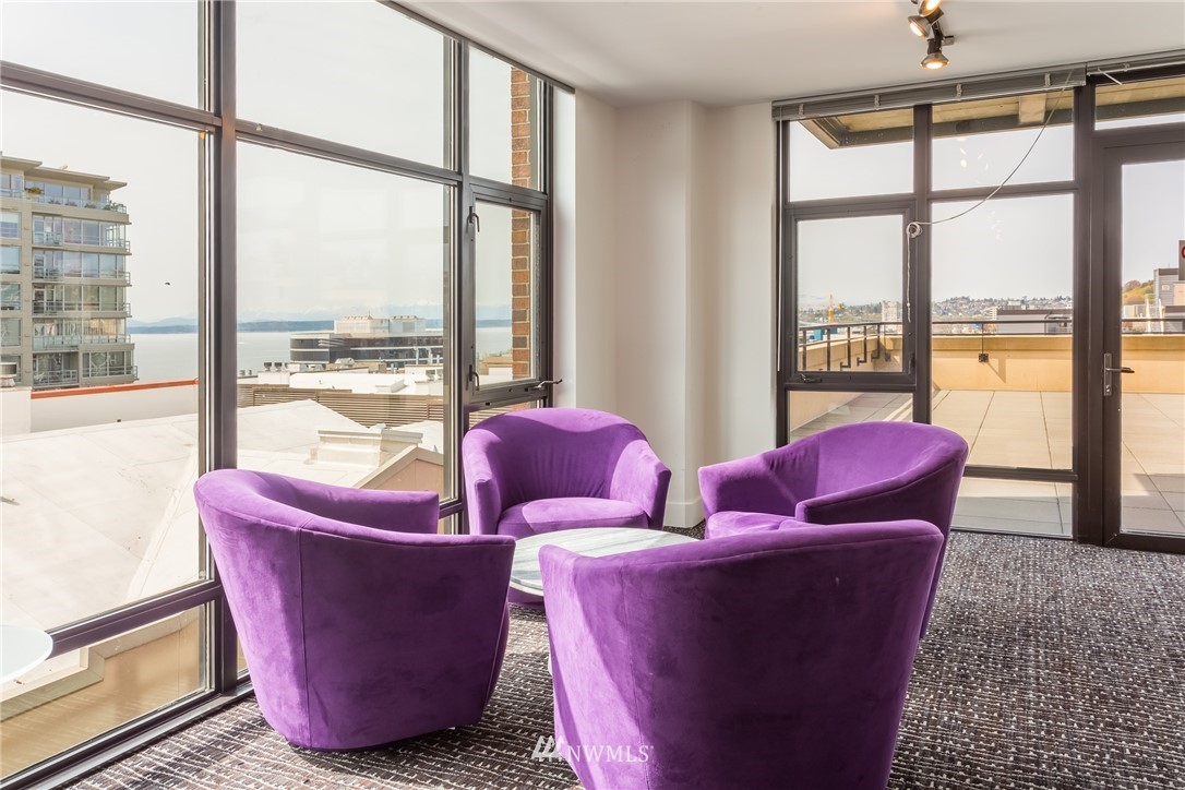 2911 2nd Avenue, Unit 903 Seattle, WA 98121 - Photo 25 of 25 a living room with furniture and a floor to ceiling window