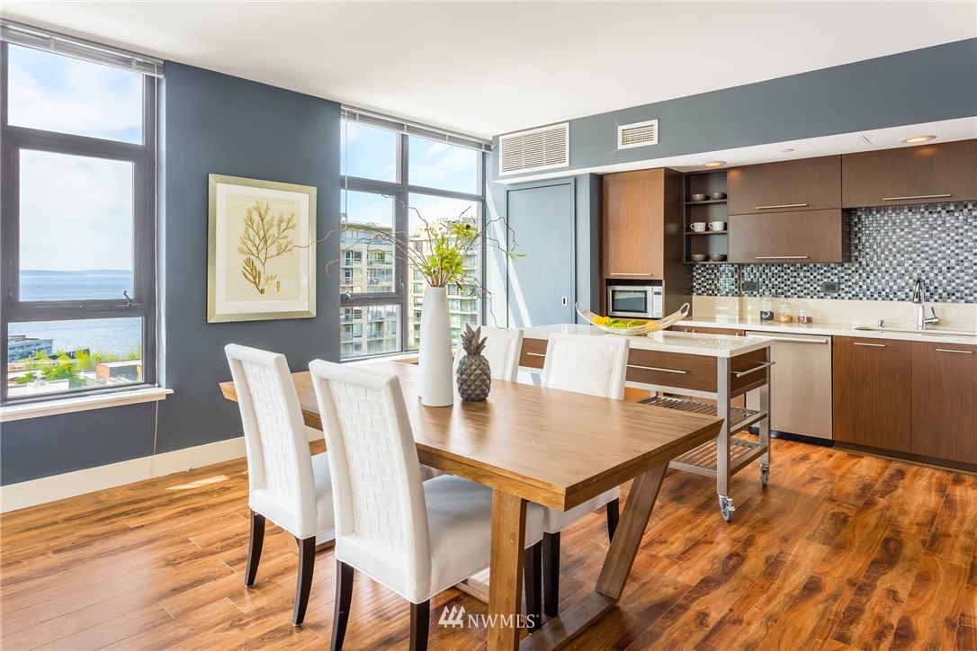 2911 2nd Avenue, Unit 903 Seattle, WA 98121 - Photo 9 of 25 a dining room with furniture and wooden floor