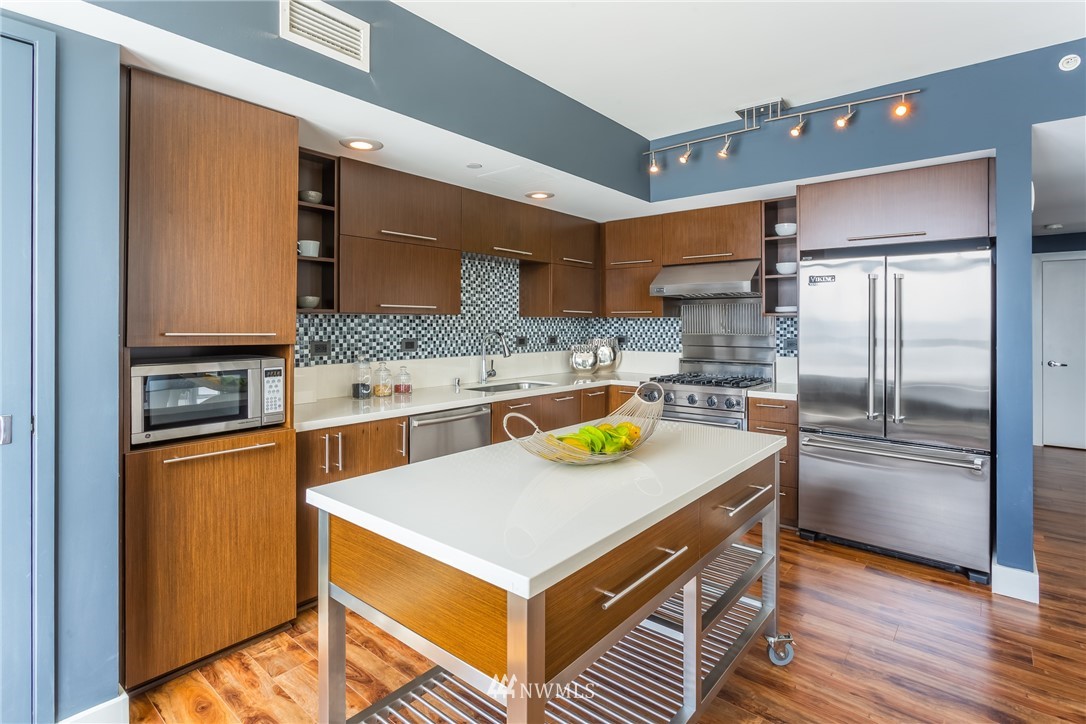 2911 2nd Avenue, Unit 903 Seattle, WA 98121 - Photo 10 of 25 a kitchen with a refrigerator and a sink
