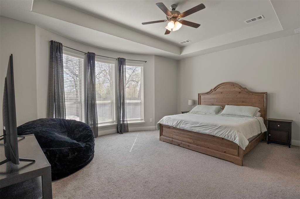 4002 Magnolia Ridge Drive Melissa, TX 75454 - Photo 12 of 36 a spacious bedroom with a bed a couch and a large window