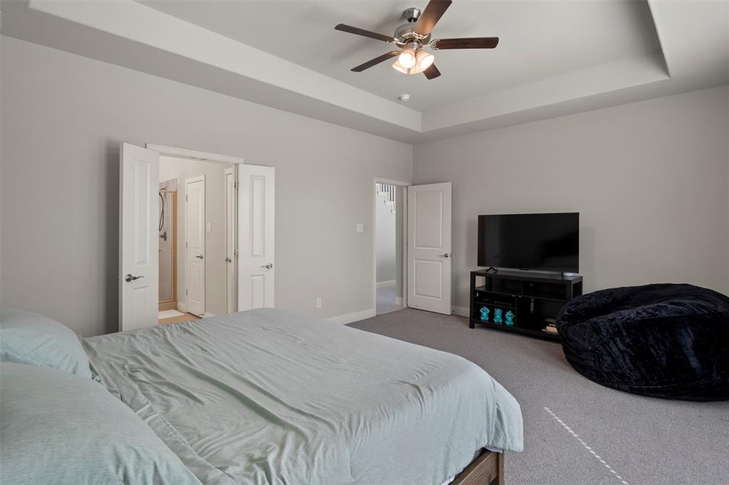 4002 Magnolia Ridge Drive Melissa, TX 75454 - Photo 13 of 36 a bedroom with a bed and a flat screen tv