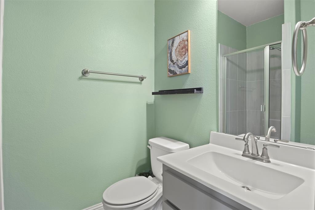 4002 Magnolia Ridge Drive Melissa, TX 75454 - Photo 16 of 36 a bathroom with a toilet sink and vanity