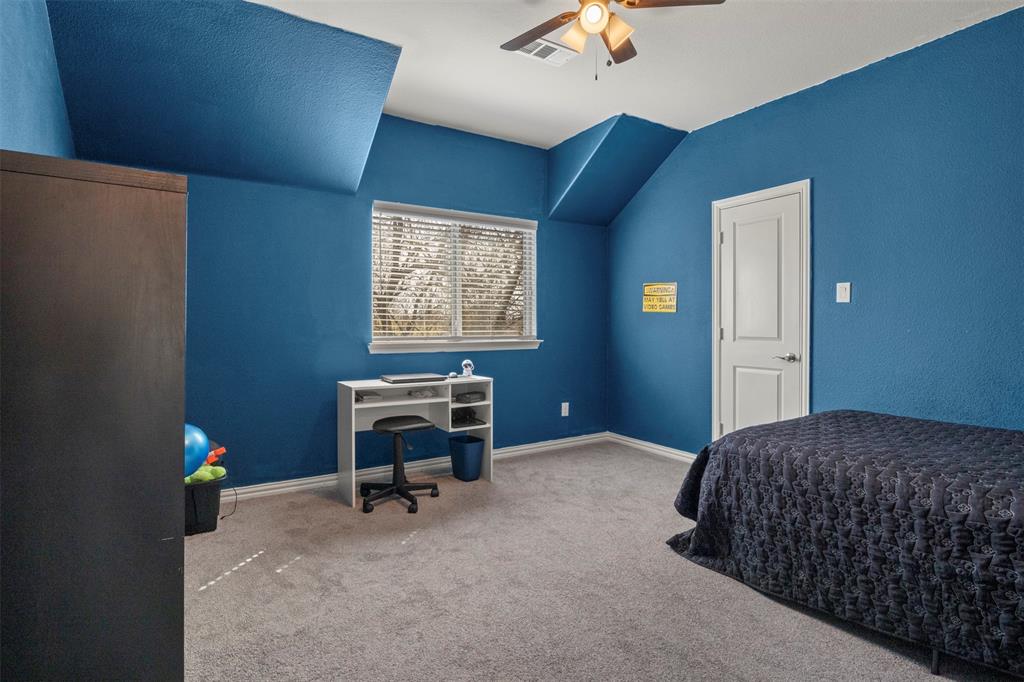 4002 Magnolia Ridge Drive Melissa, TX 75454 - Photo 17 of 36 a bedroom with a bed and a desk