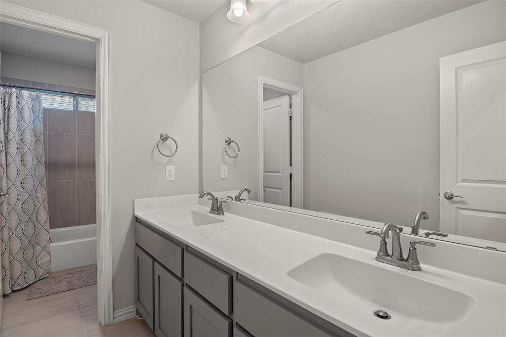 4002 Magnolia Ridge Drive Melissa, TX 75454 - Photo 21 of 36 a bathroom with a sink and a mirror