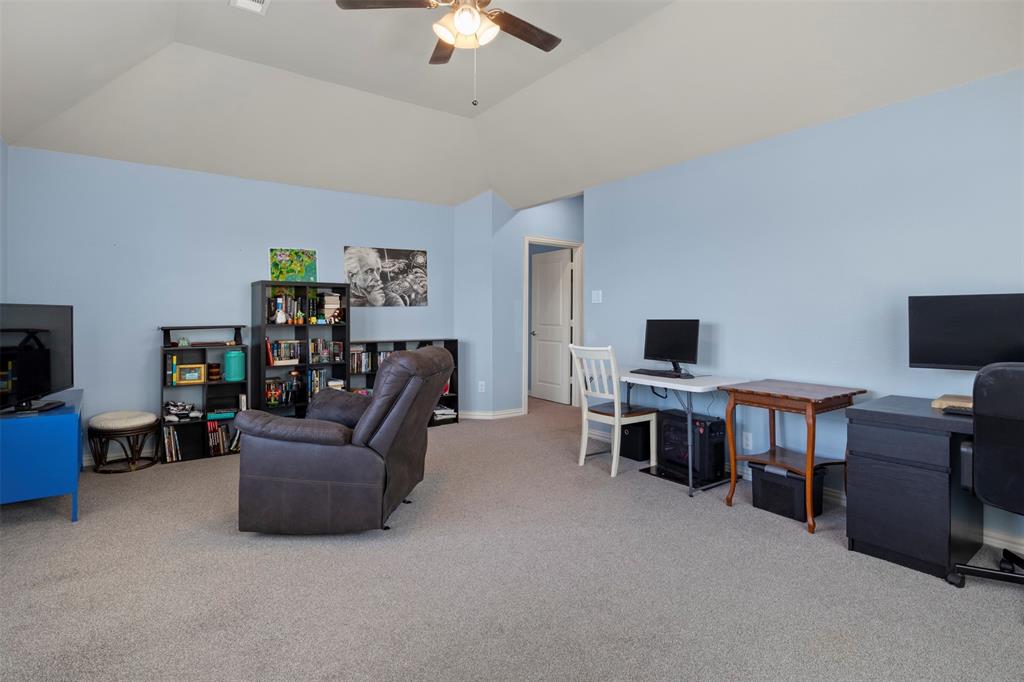 4002 Magnolia Ridge Drive Melissa, TX 75454 - Photo 23 of 36 a living room with furniture and a flat screen tv