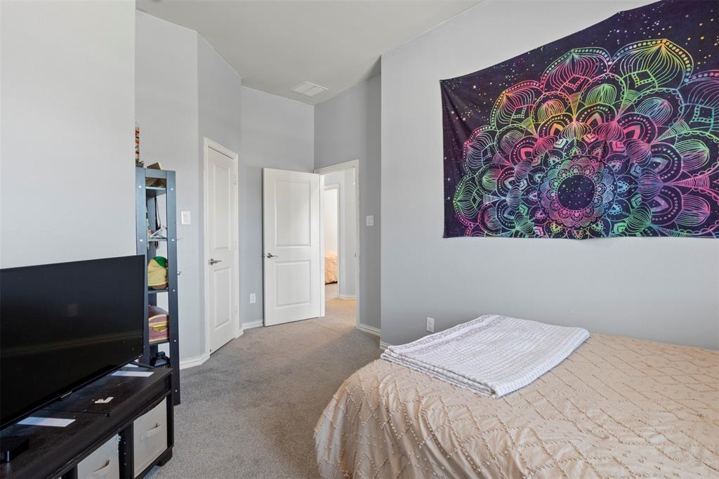 4002 Magnolia Ridge Drive Melissa, TX 75454 - Photo 25 of 36 a bedroom with a bed and a flat screen tv