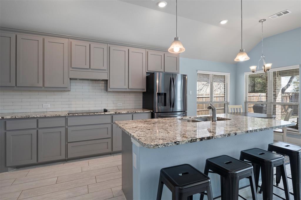 4002 Magnolia Ridge Drive Melissa, TX 75454 - Photo 9 of 36 a kitchen with stainless steel appliances granite countertop a sink refrigerator and cabinets
