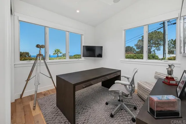 a spacious bedroom with a bed a couch and a large window
