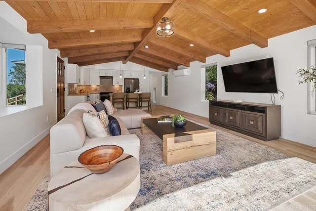 a kitchen with stainless steel appliances kitchen island granite countertop a sink cabinets and wooden floor