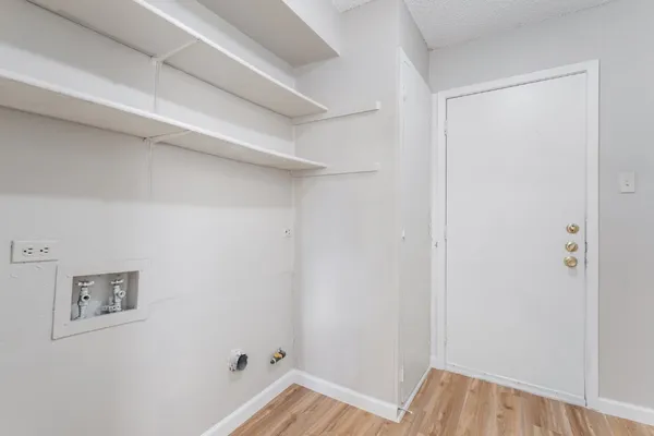 a view of a bedroom with wooden floor