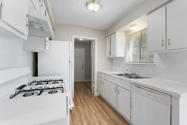 a kitchen with a sink stove and refrigerator